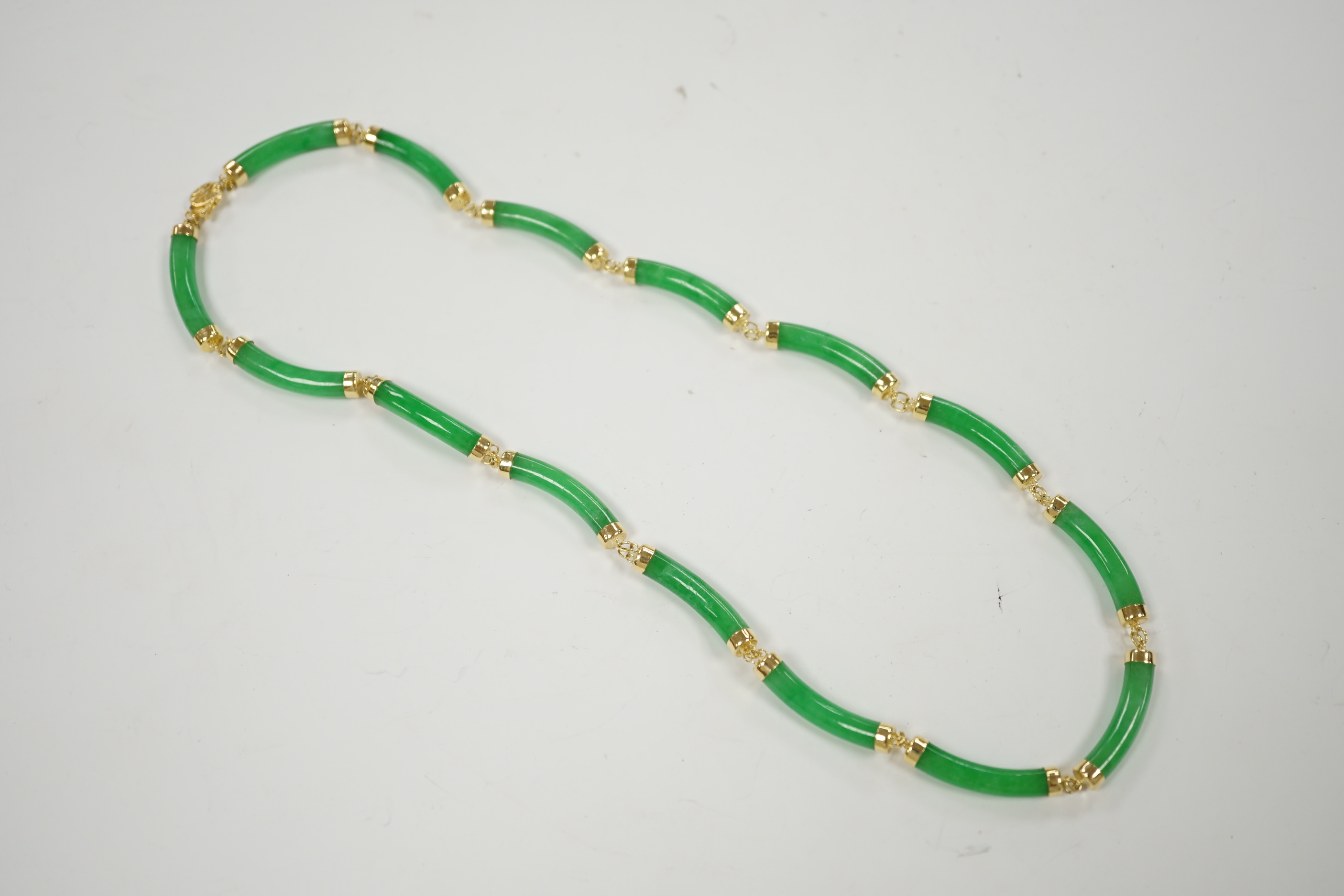 A 14k yellow metal and curved jade link necklace, 42cm, gross weight 25 grams.